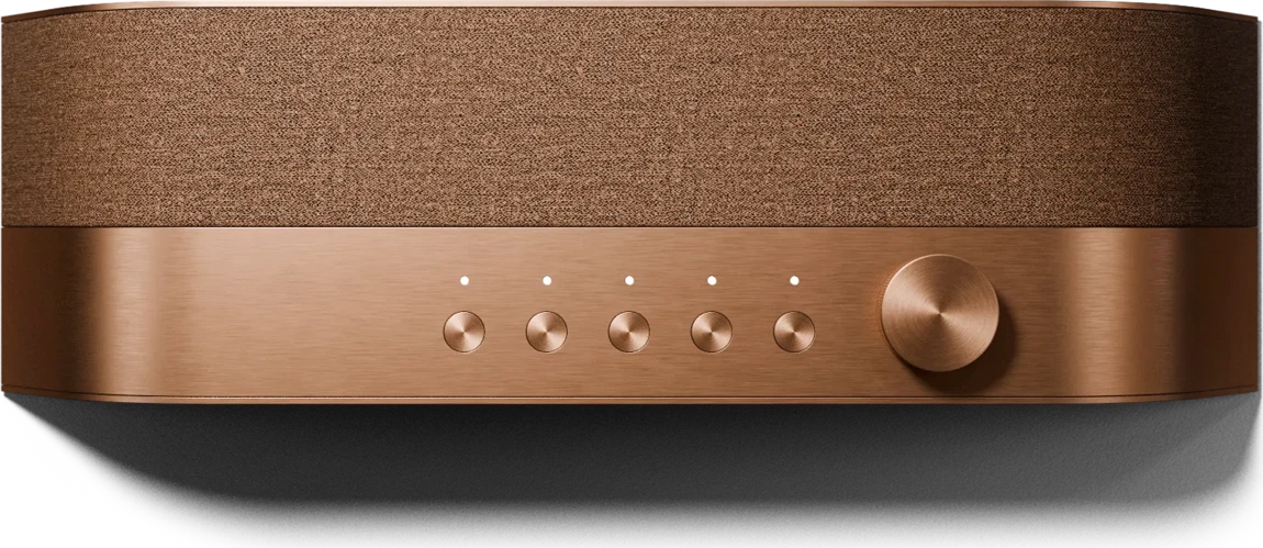 The Radio* seen from the front: a fabric grille above a bronze-finished panel with five buttons and a dial